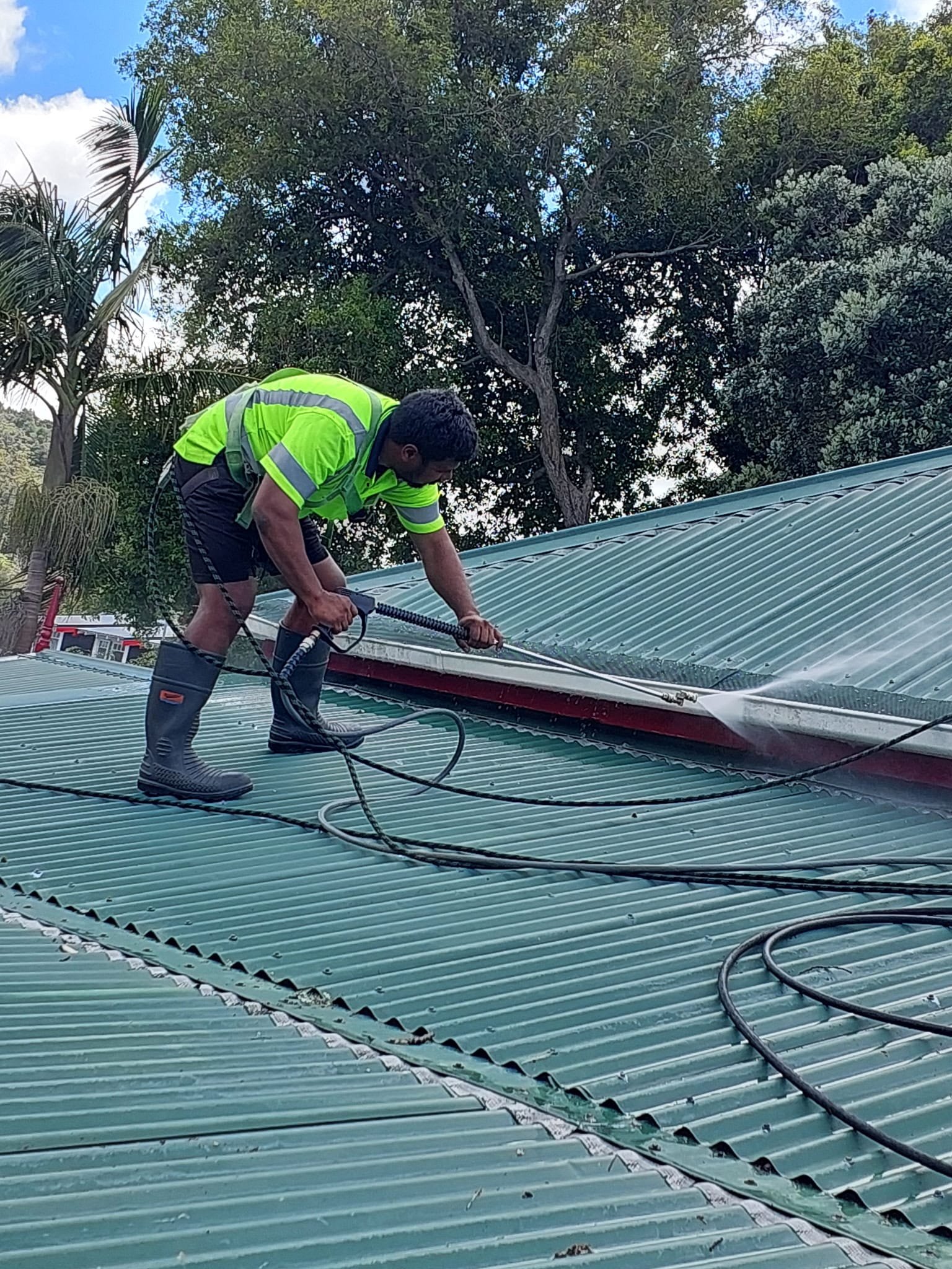 Exterior cleaning work on a residential roof
