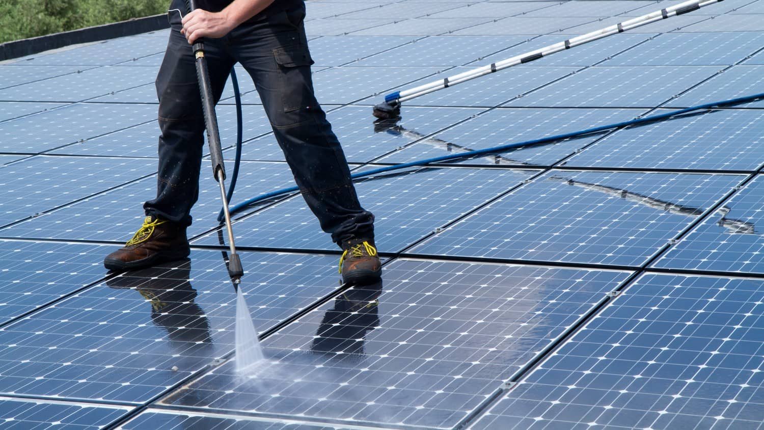 Solar panels being cleaned on a property roof